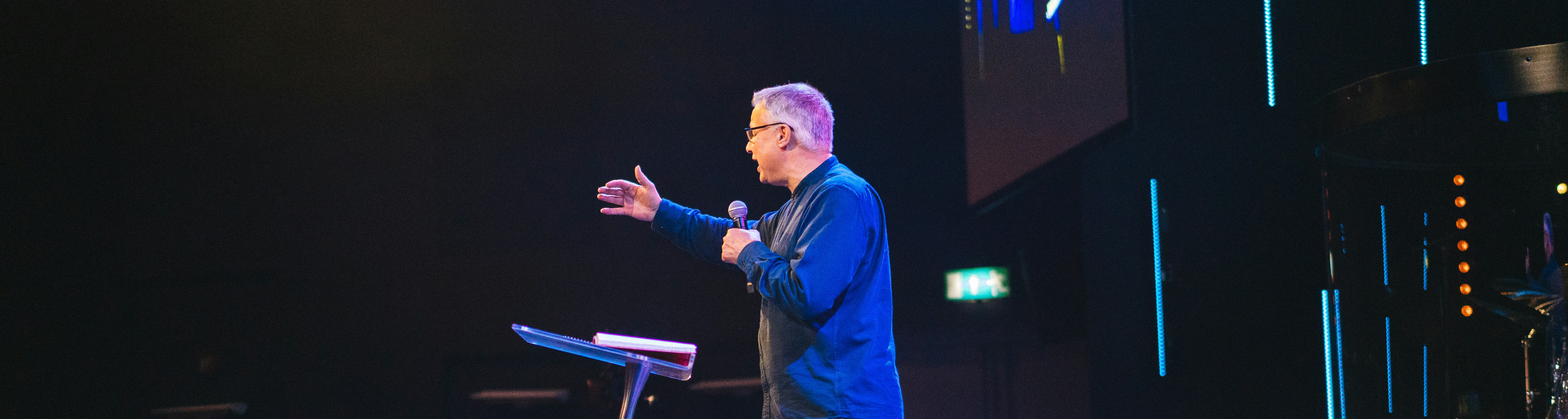 Pastor preaching from a church stage