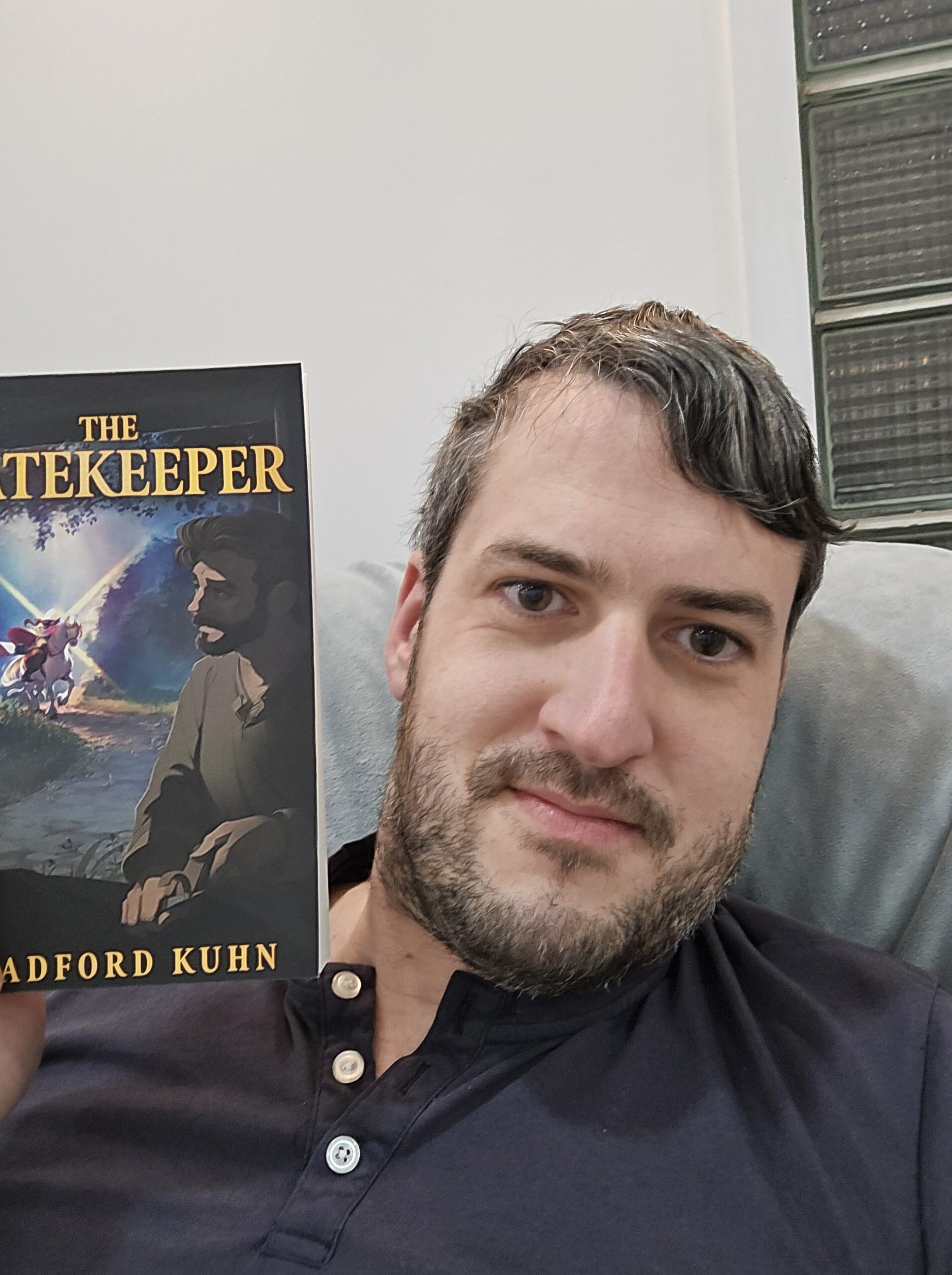 Author Bradford Kuhn holding his book