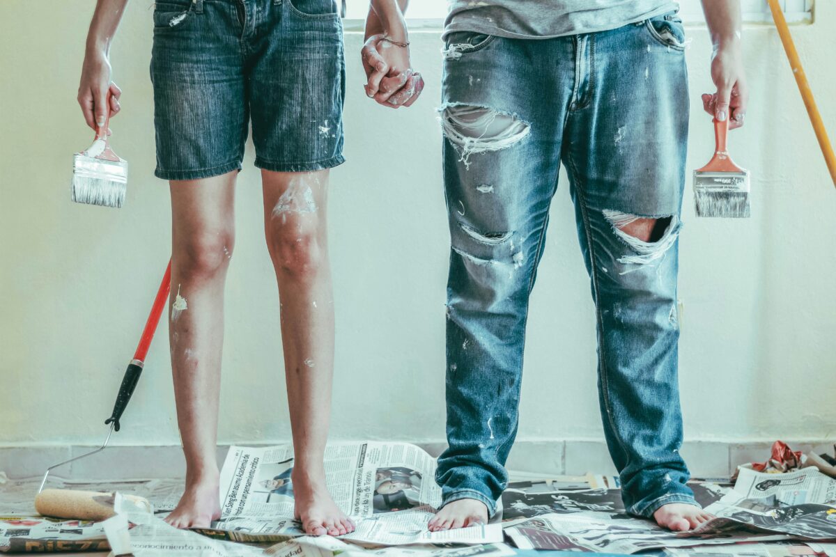 man and woman's legs spattered in paint from remodeling